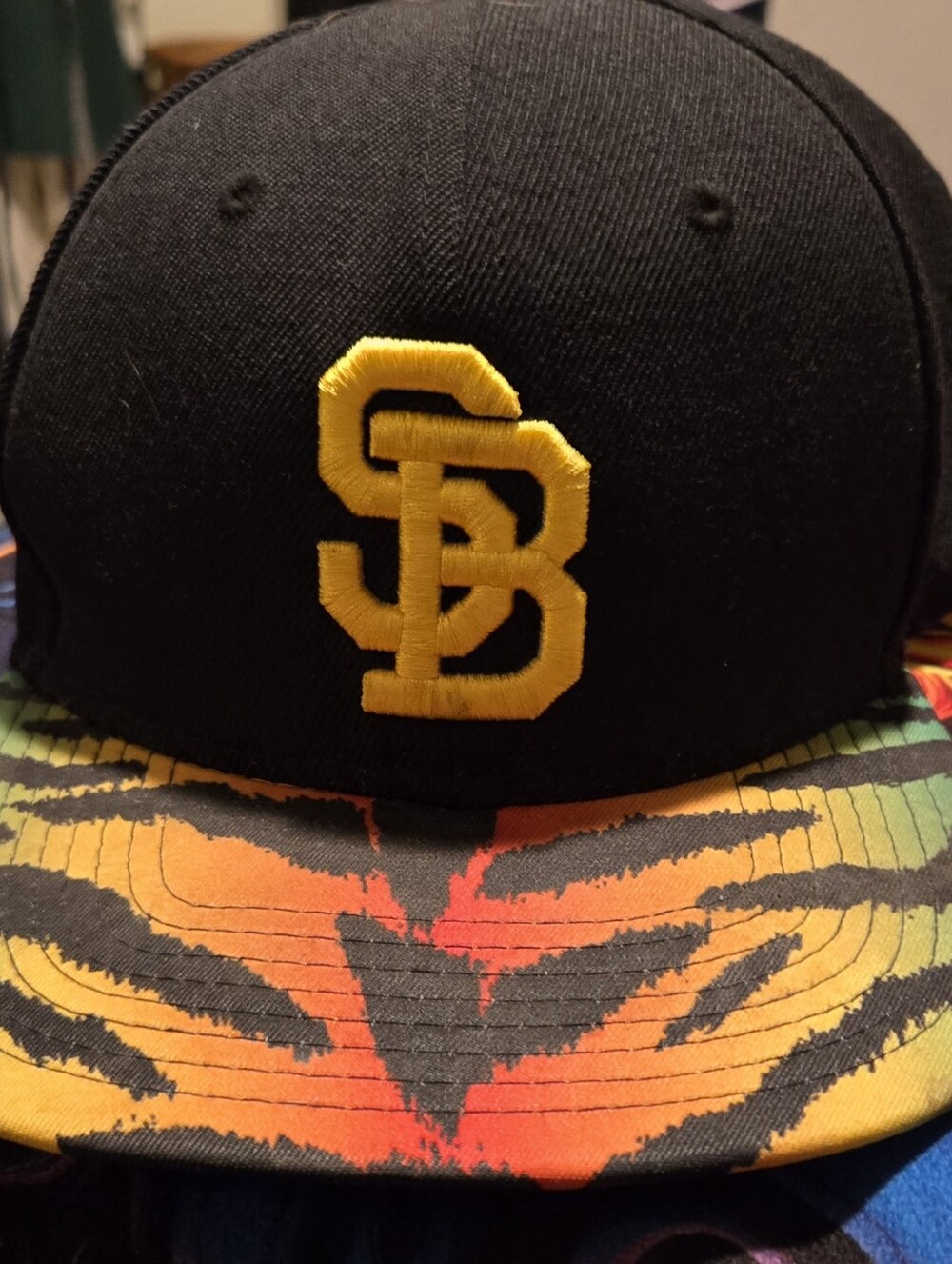 Black Snapback Hat with Yellow SB Logo and Multicolor Brim